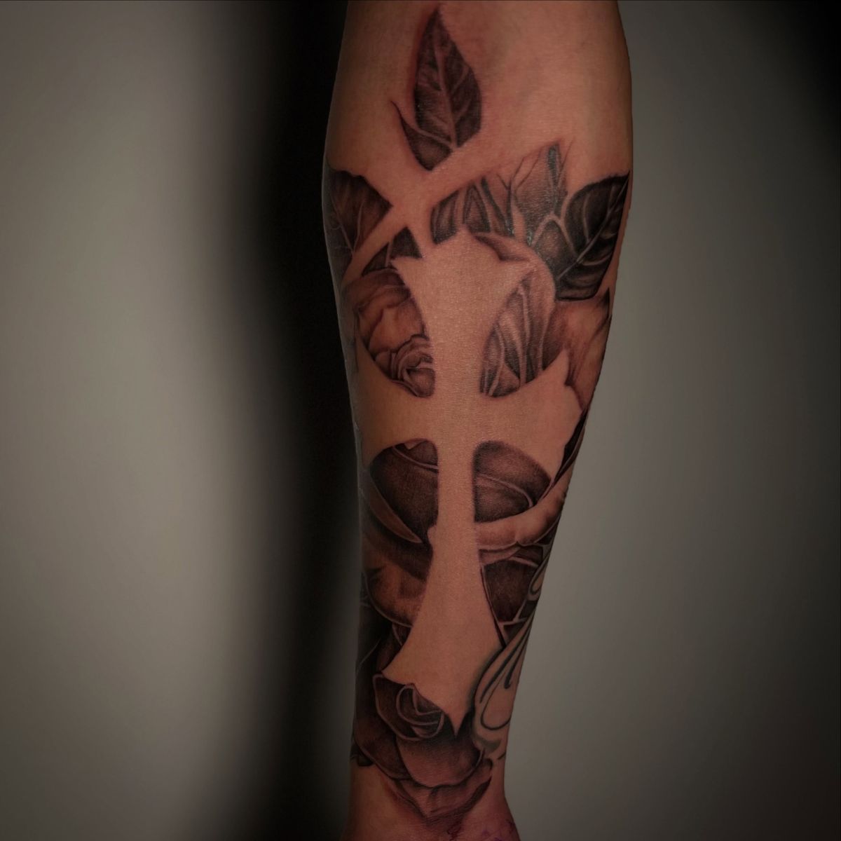 Negative-space cross with roses by Joel Andrade