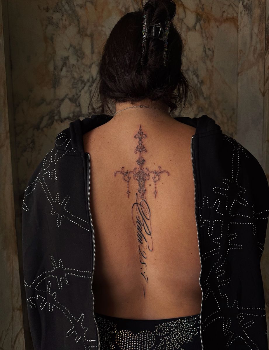 Fine-line spine piece by Kristiana